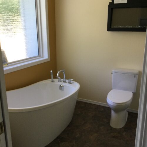 Reversible tub to shower conversion with low step entry for mobility friendly bathroom accessibility.