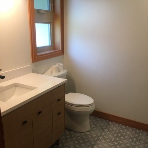 Reversible tub to shower conversion with low step entry for mobility friendly bathroom accessibility.