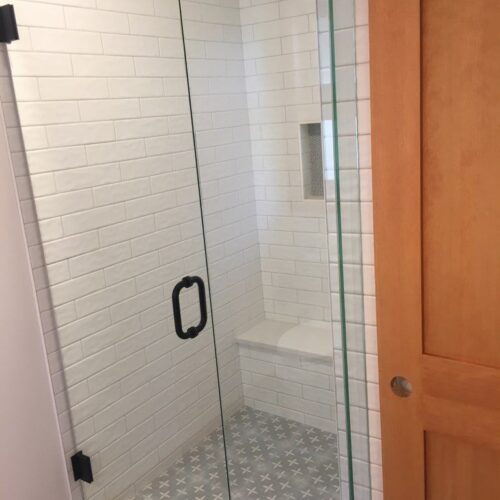 Reversible tub to shower conversion with low step entry for mobility friendly bathroom accessibility.