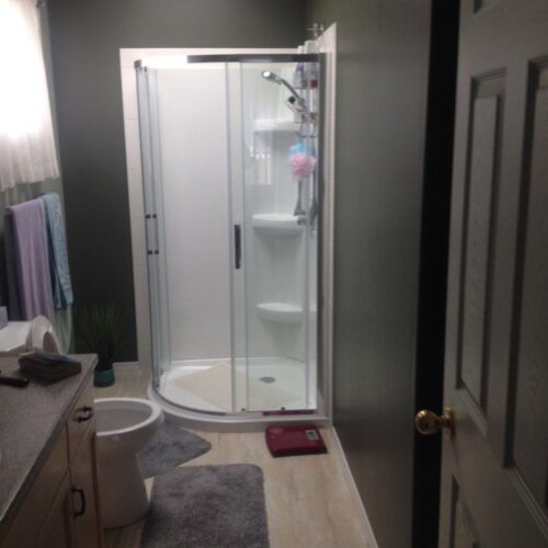 Reversible tub to shower conversion with low step entry for mobility friendly bathroom accessibility.